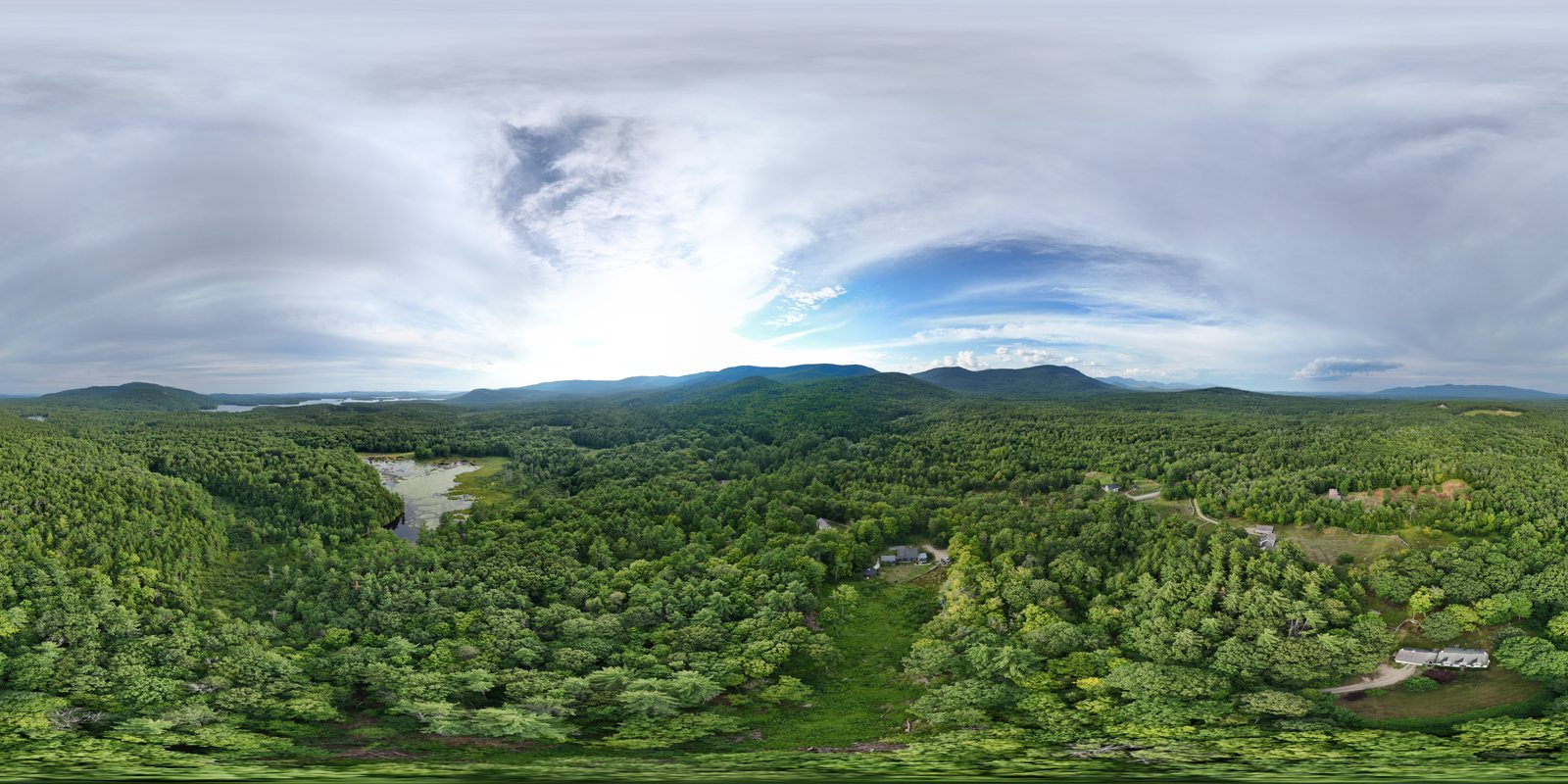 Aerial panorama over Moultonborough forest and mountains
